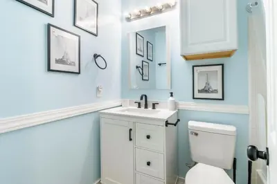 a bathroom with a white toilet and a sink at Charming 3BR Home with Free Parking & Game Room in Panama City