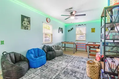 a living room with two couches and a table at Charming 3BR Home with Free Parking & Game Room in Panama City