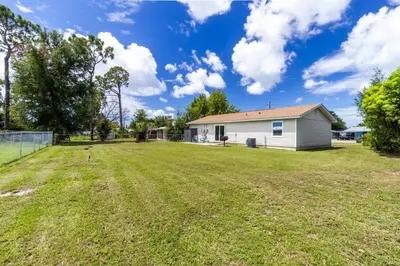 an empty yard in front of a house at Charming 3BR Home with Free Parking & Game Room in Panama City