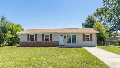 a small red and white house with a driveway at Charming 3BR Home with Free Parking & Game Room in Panama City