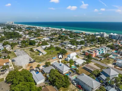 an aerial view of a city with the beach at Charming 3/2 Beach House w/ POOL & Golf Cart INCLUDED - 1 Min Walk to Beach in Panama City Beach