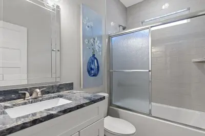 a bathroom with a toilet and a sink and a shower at Charming 3/2 Beach House w/ POOL & Golf Cart INCLUDED - 1 Min Walk to Beach in Panama City Beach