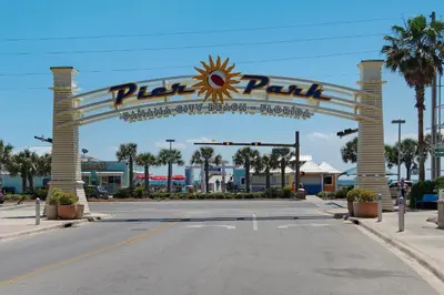 a sign for a parking lot at a theme park at Charming 3/2 Beach House w/ POOL & Golf Cart INCLUDED - 1 Min Walk to Beach in Panama City Beach