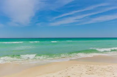 a view of a beach with the ocean at Charming 3/2 Beach House w/ POOL & Golf Cart INCLUDED - 1 Min Walk to Beach in Panama City Beach