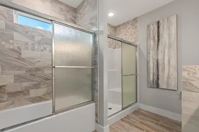 a shower in a bathroom with a glass door at Charming 3/2 Beach House w/ POOL & Golf Cart INCLUDED - 1 Min Walk to Beach in Panama City Beach