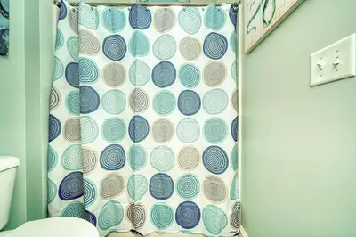 a shower curtain in a bathroom with a toilet at Vista del Mar I Short Walk to the Beach 301 in Panama City Beach