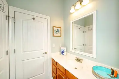 a bathroom with a sink and a mirror at Vista del Mar I Short Walk to the Beach 301 in Panama City Beach