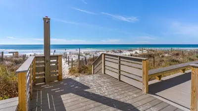 a wooden walkway to the beach with the ocean at Eastern Shores 215 in Santa Rosa Beach