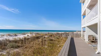 a beach house with a boardwalk leading to the beach at Eastern Shores 215 in Santa Rosa Beach