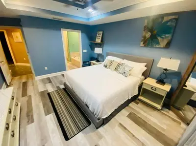 a bedroom with a bed and a blue wall at Newly renovated modern, spacious & quiet location in Callaway