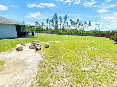 a backyard with a picnic table and benches at Newly renovated modern, spacious & quiet location in Callaway
