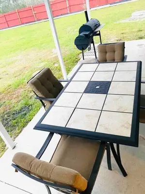 a table and chairs on a patio with a field at Newly renovated modern, spacious & quiet location in Callaway
