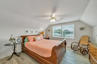 a bedroom with a bed and a ceiling fan at Nearby Beach l Friends & Family l Pet-Friendly in Panama City Beach