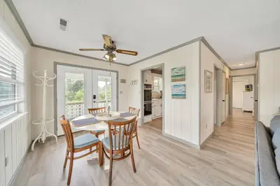 a dining room and living room with a table and chairs at Nearby Beach l Friends & Family l Pet-Friendly in Panama City Beach