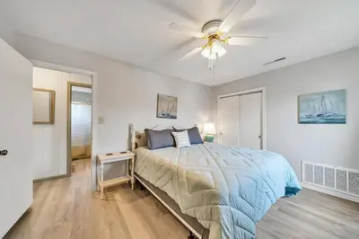 a bedroom with a bed and a ceiling fan at Nearby Beach l Friends & Family l Pet-Friendly in Panama City Beach
