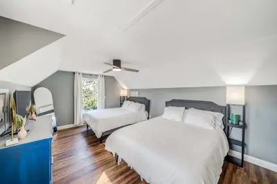 a bedroom with two beds and a ceiling fan at Dolphin's Den in Panama City Beach