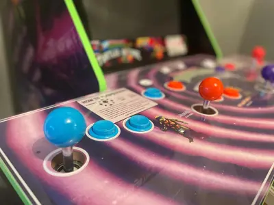 a close up of a pinball game with balls on it at Dolphin's Den in Panama City Beach