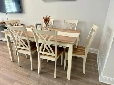 a dining room table with white chairs around it at Close to beach, Pier Park, Game Room Theater Room in Panama City Beach
