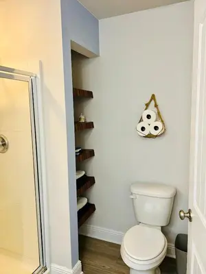 a bathroom with a toilet and a book shelf at Close to beach, Pier Park, Game Room Theater Room in Panama City Beach