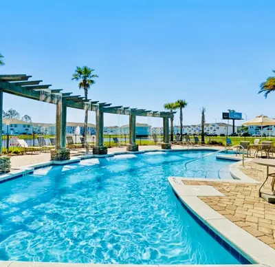 a swimming pool at a resort with palm trees at Close to beach, Pier Park, Game Room Theater Room in Panama City Beach