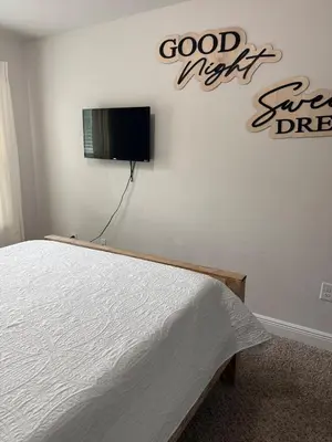 a bedroom with a bed and a sign on the wall at Close to beach, Pier Park, Game Room Theater Room in Panama City Beach