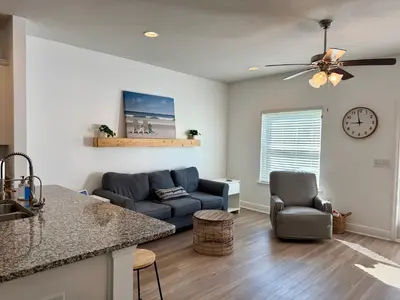 a living room with a couch and a table at Close to beach, Pier Park, Game Room Theater Room in Panama City Beach