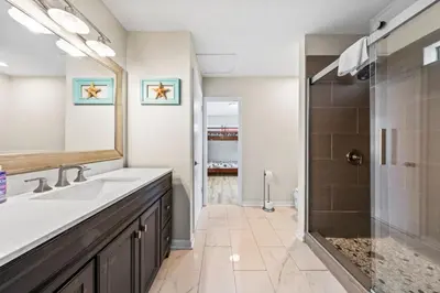 a bathroom with a sink and a shower at Beachcombers Nook, Firepit, yard, Sleeps 8, Walk to Beach in Panama City Beach