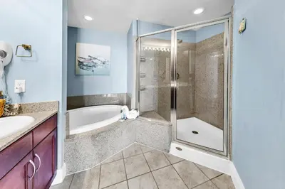 a bathroom with a shower and a tub at Laketown Wharf 927 in Panama City Beach