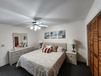 a bedroom with a bed and a ceiling fan at Gulf Highlands Beach Townhouse in Panama City Beach