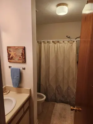 a bathroom with a shower and a sink and a toilet at Gulf Highlands Beach Townhouse in Panama City Beach