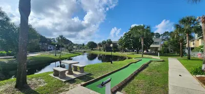 a park with a river and benches next to a canal at Gulf Highlands Beach Townhouse in Panama City Beach