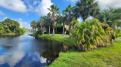 a river with palm trees on the side of it at Gulf Highlands Beach Townhouse in Panama City Beach