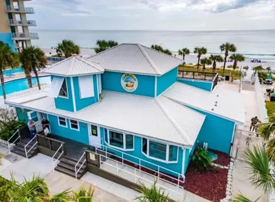 an aerial view of a blue building with the beach in the background at Gulf Highlands Beach Townhouse in Panama City Beach