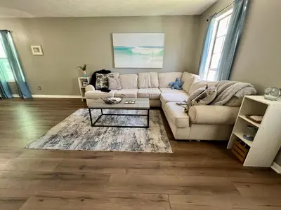 a living room with a couch and a coffee table at Cozy Two-Bedroom Cottage-5min walk to beach! in Panama City Beach