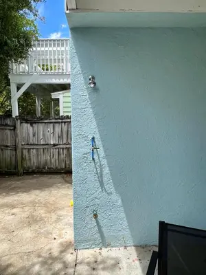 a blue wall with a figurine on the side of a house at Cozy Two-Bedroom Cottage-5min walk to beach! in Panama City Beach
