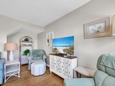 a living room with a couch and chairs at Pinnacle Port A-305 in Panama City Beach
