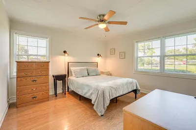 a bedroom with a bed and a ceiling fan at Walk to Ocean Home in Panama City Beach! in Panama City Beach