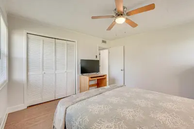 a bedroom with a bed and a ceiling fan at Walk to Ocean Home in Panama City Beach! in Panama City Beach