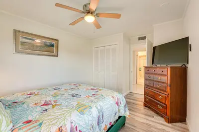 a bedroom with a bed and a flat screen tv at Walk to Ocean Home in Panama City Beach! in Panama City Beach