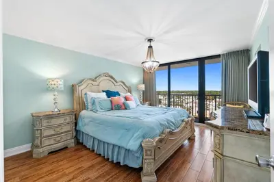 a bedroom with a bed and a television in it at Pelican Walk 1012 in Panama City Beach