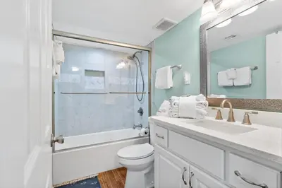 a bathroom with a toilet and a sink and a shower at Pelican Walk 1012 in Panama City Beach