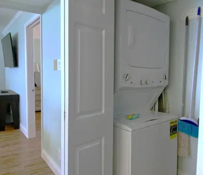 a kitchen with a washer and dryer in a room at Pelican Walk 1012 in Panama City Beach