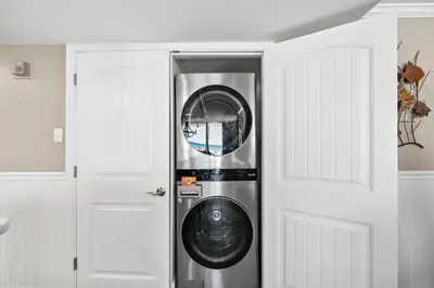 a washer and dryer in a room next to a door at Pelican Walk 101 in Panama City Beach