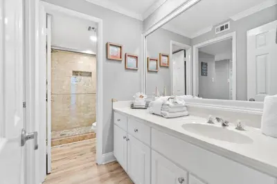 a white bathroom with a sink and a shower at Pelican Walk 308 in Panama City Beach