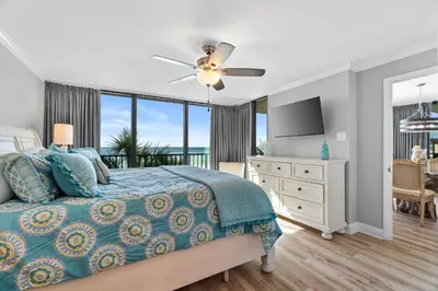a bedroom with a bed with a view of the ocean at Pelican Walk 308 in Panama City Beach
