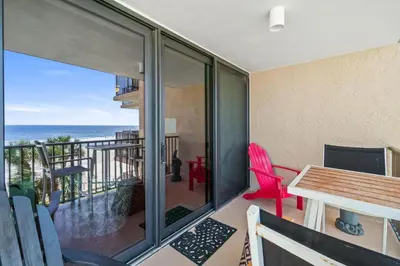 a balcony with a table and chairs and the ocean at Pelican Walk 309 in Panama City Beach