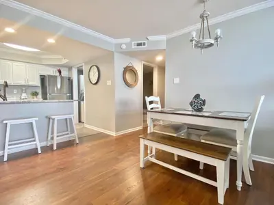 a kitchen and dining room with a table and chairs at Pelican Walk 309 in Panama City Beach