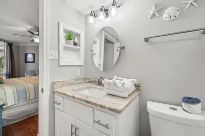 a bathroom with a sink and a mirror at Pelican Walk 309 in Panama City Beach
