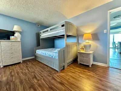 a childs bedroom with a bunk bed and a lamp at Pelican Walk 312 in Panama City Beach