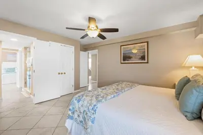 a bedroom with a bed and a ceiling fan at Pelican Walk 401 in Panama City Beach